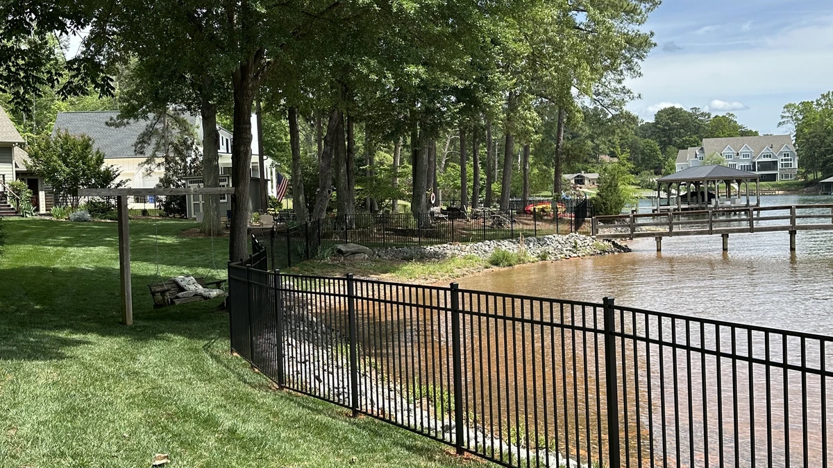 A new pressure treated privacy fence running the length of a back yard in Mooresville