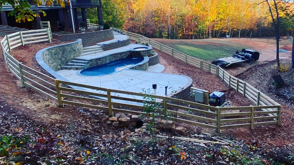 A new pressure treated privacy fence running the length of a back yard in Mooresville