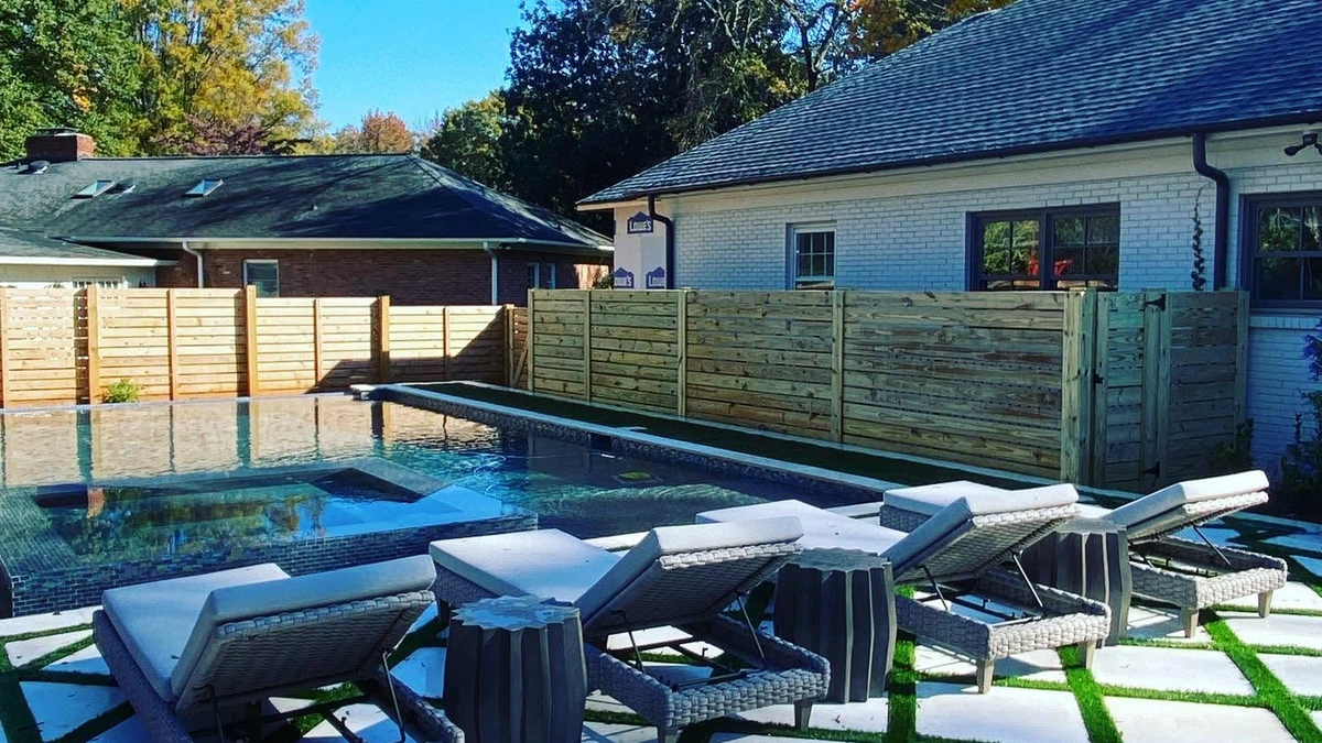 A new pressure treated privacy fence running the length of a back yard in Mooresville